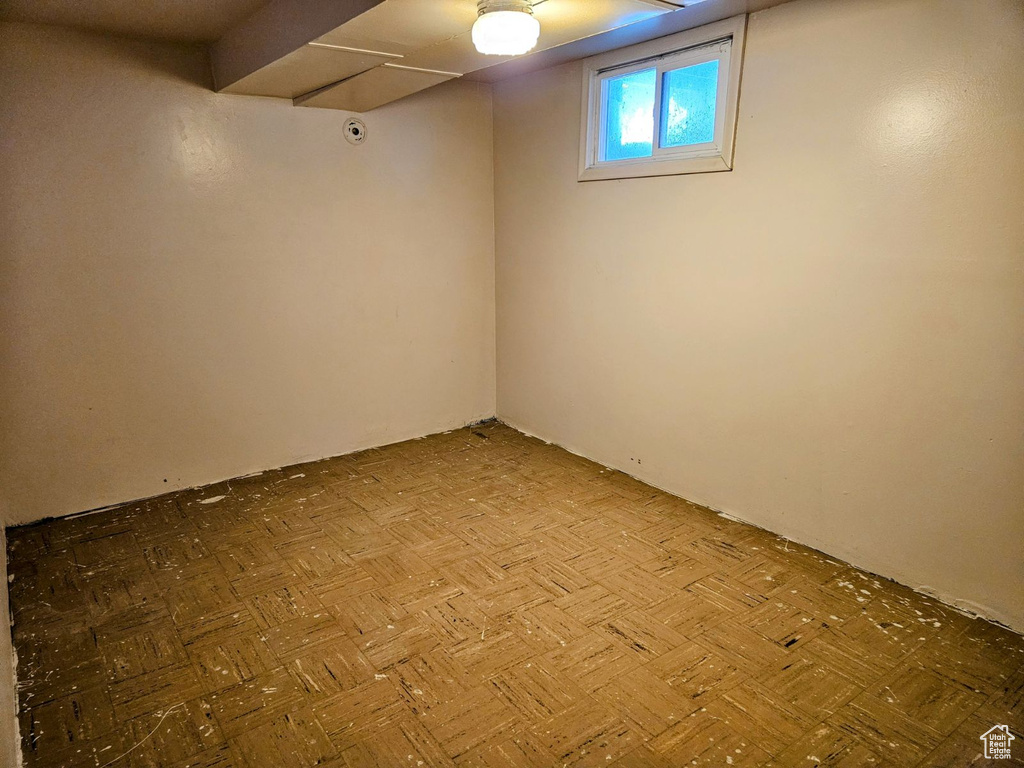 Basement featuring light parquet flooring