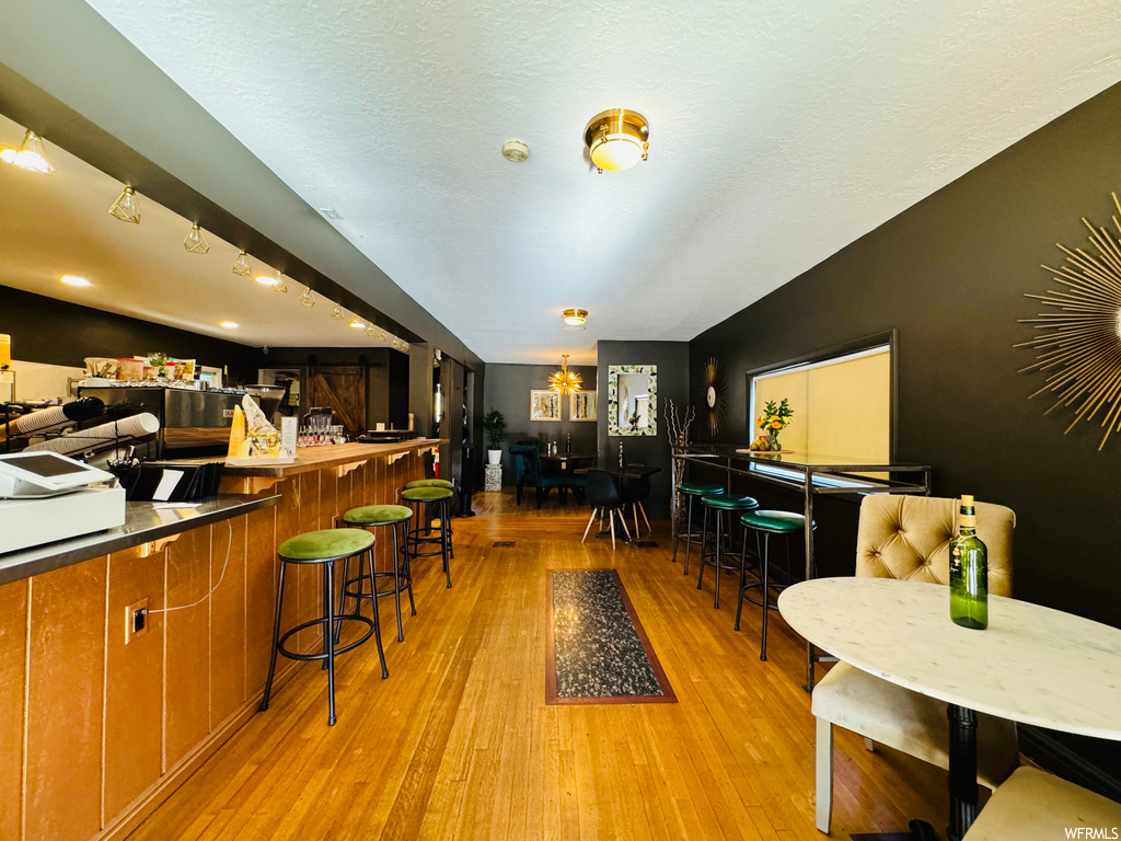 Kitchen featuring light hardwood / wood-style flooring and a kitchen bar