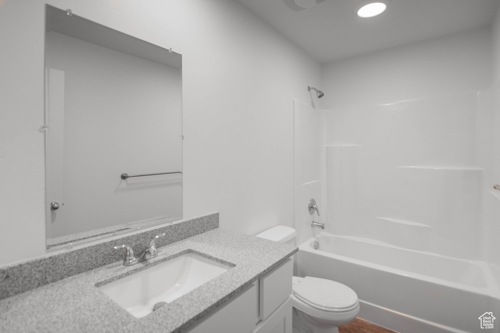 Full bathroom featuring vanity, toilet, and  shower combination