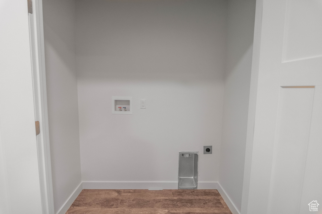 Clothes washing area featuring wood-type flooring, hookup for an electric dryer, and washer hookup