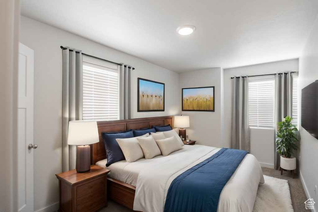 Bedroom featuring light carpet