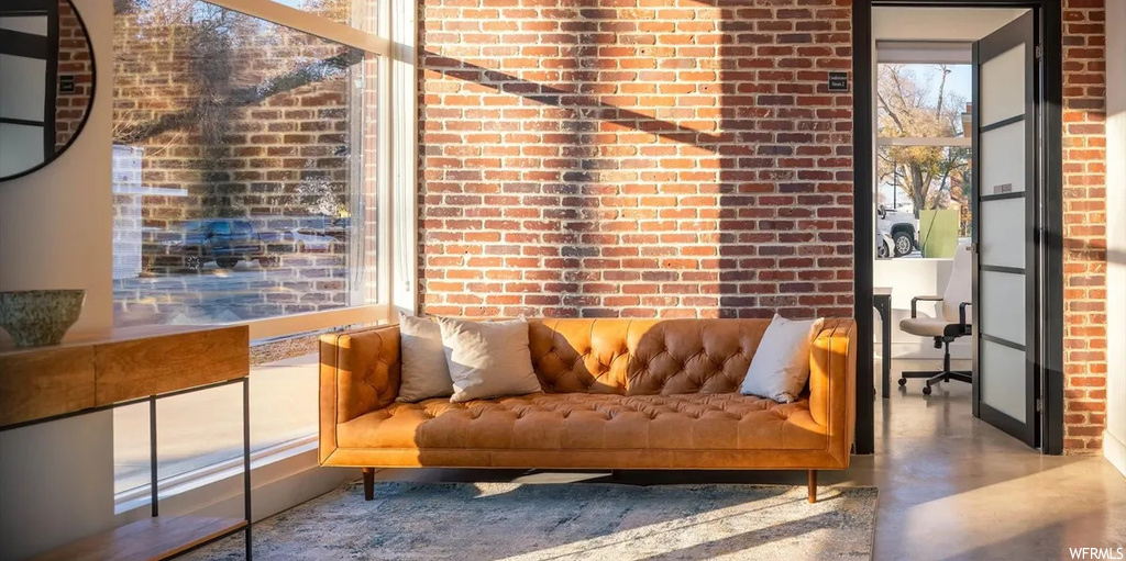 Sitting room with brick wall