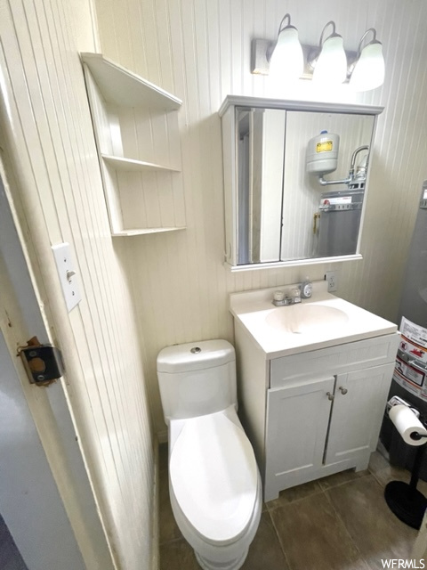Bathroom featuring toilet, tile floors, and large vanity