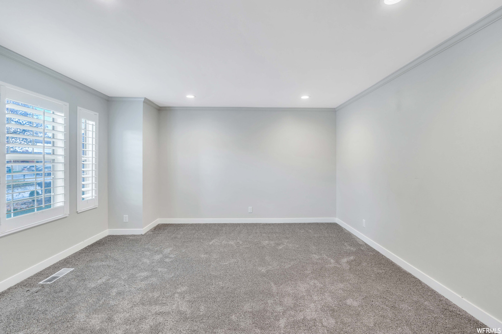 Spare room with carpet and crown molding