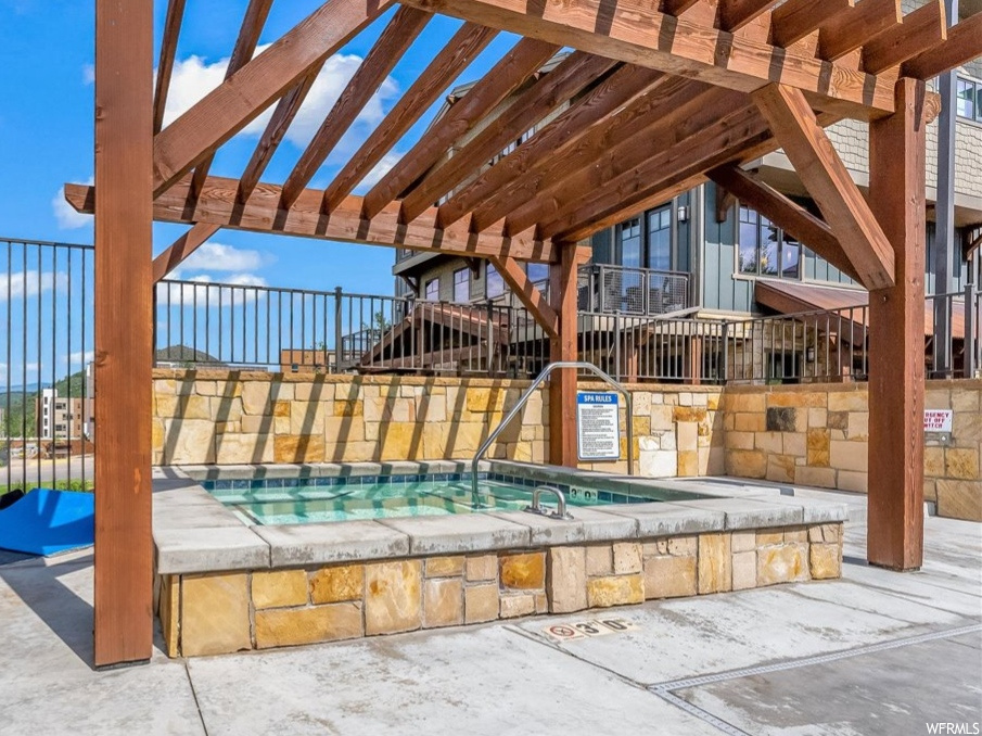 View of pool with a pergola, a patio area, and a community hot tub
