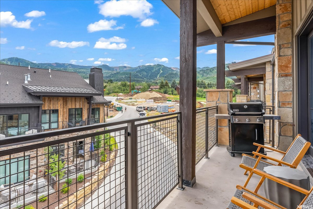 Balcony featuring area for grilling and a mountain view
