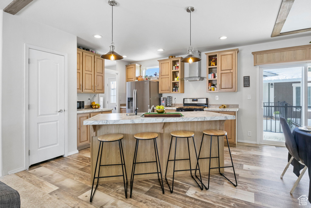 Kitchen featuring a center island with sink, light wood-type flooring, and appliances with stainless steel finishes