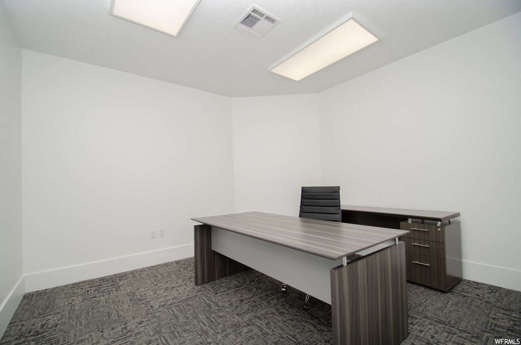 Office area with dark colored carpet