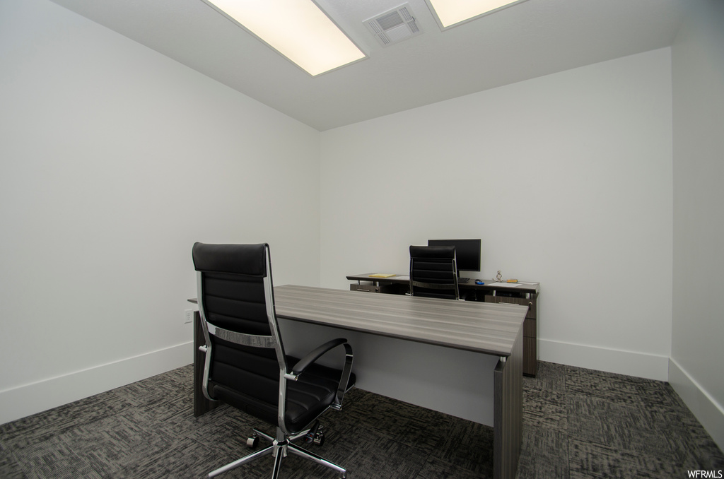 Office space with dark colored carpet