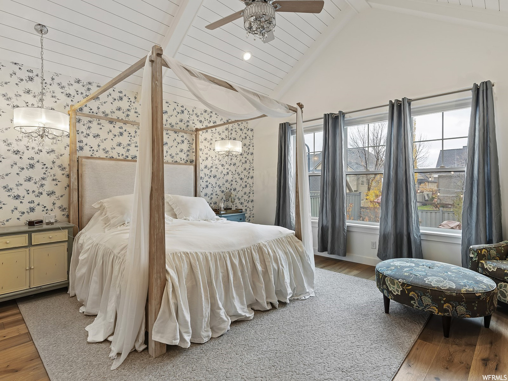 Bedroom with beamed ceiling, ceiling fan, high vaulted ceiling, and hardwood / wood-style flooring