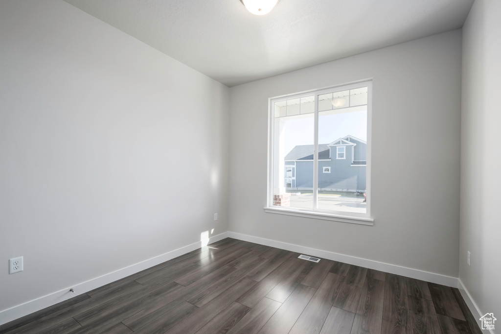 Unfurnished room featuring dark hardwood / wood-style floors