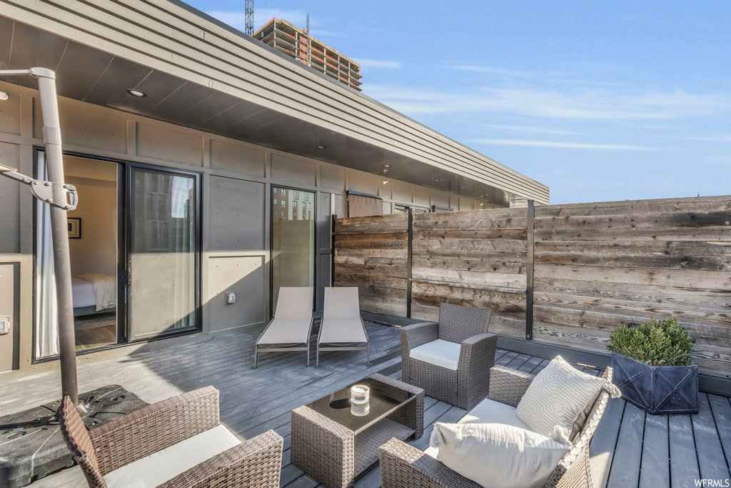 Exterior space with outdoor lounge area and a wooden deck