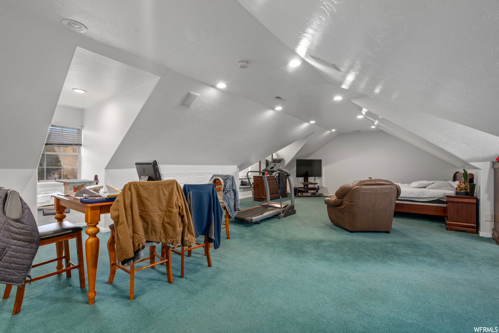 Interior space with carpet and vaulted ceiling