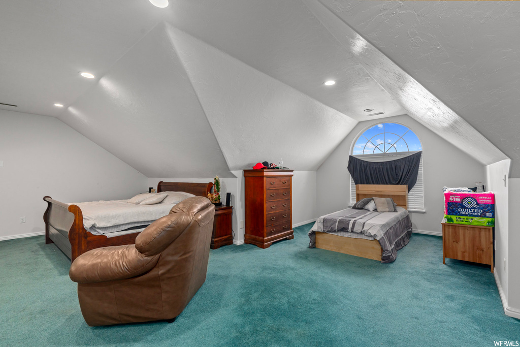 Bedroom with lofted ceiling and carpet