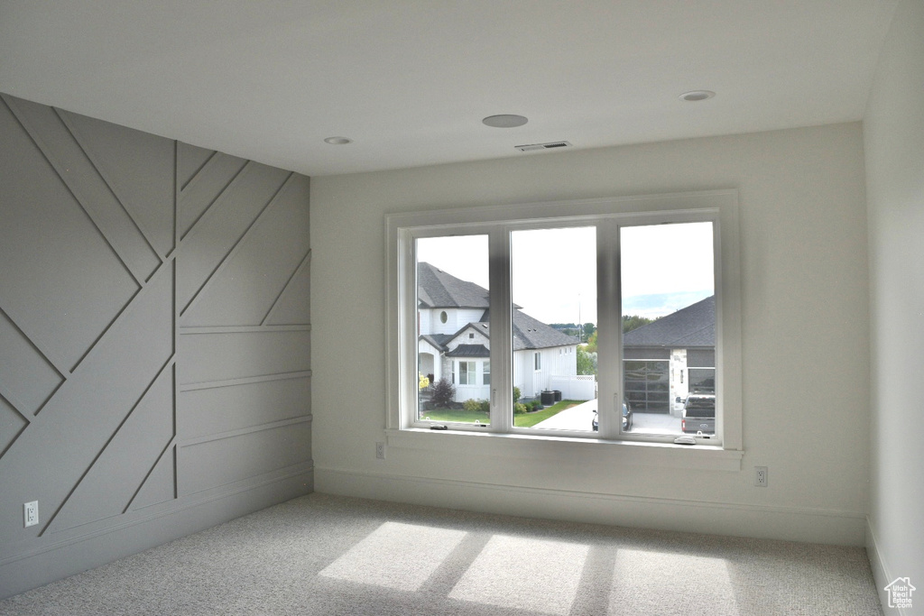 Spare room featuring light carpet