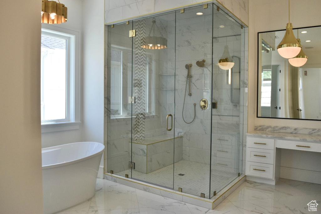 Bathroom featuring shower with separate bathtub, a healthy amount of sunlight, and tile patterned floors