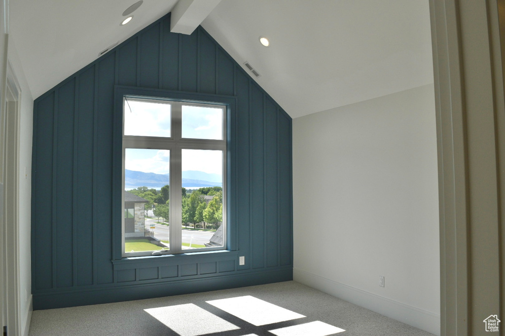 Bonus room featuring vaulted ceiling with beams and carpet floors