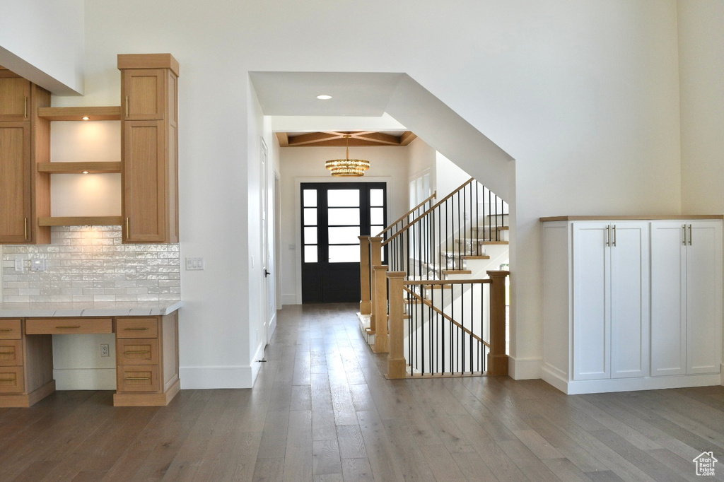 Corridor with hardwood / wood-style floors