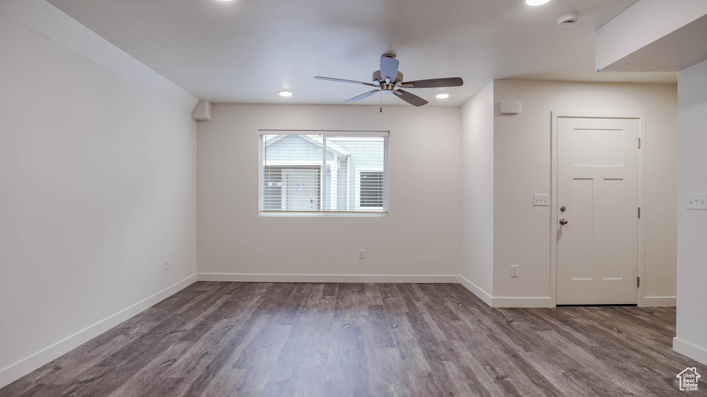 Spare room featuring ceiling fan and dark hardwood / wood-style flooring