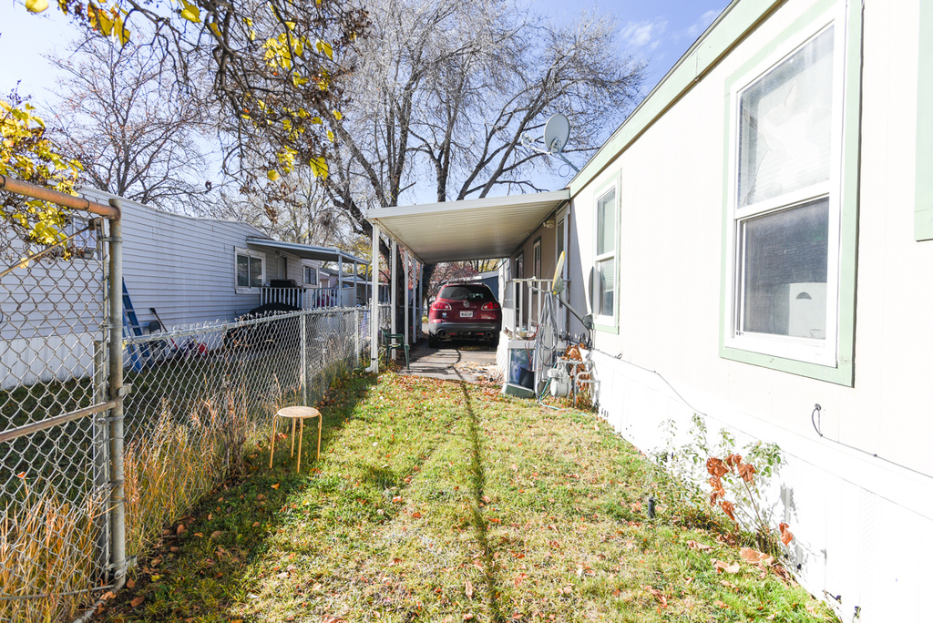 View of yard with a carport