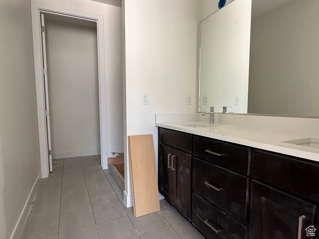 Bathroom featuring tile floors and dual vanity