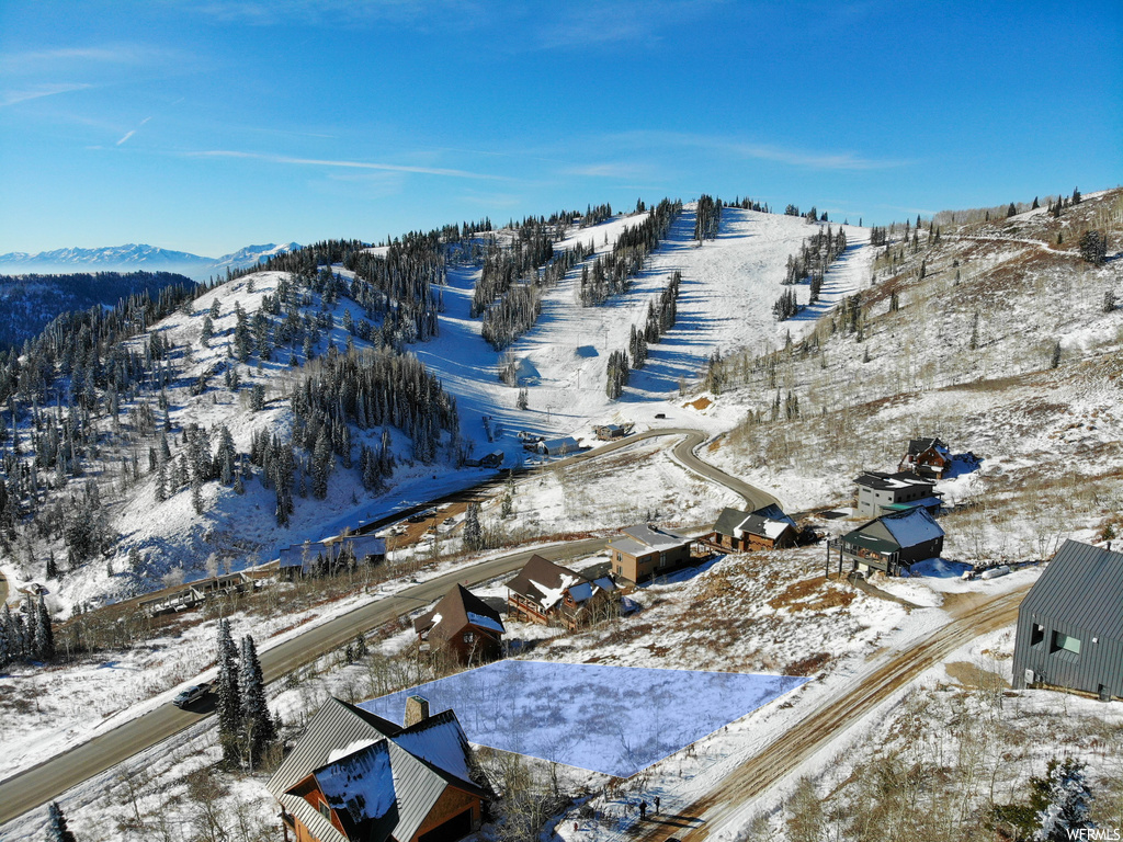 Snowy aerial view featuring a rural view and a mountain view