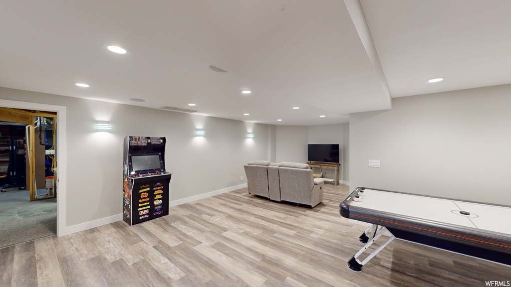 Rec room with light hardwood / wood-style floors