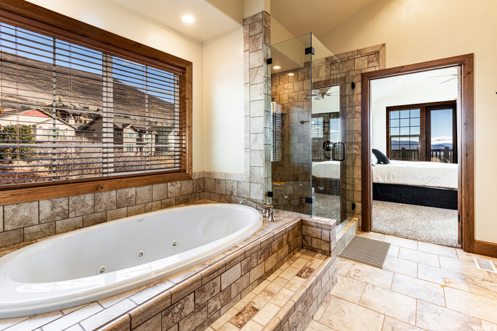 Bathroom with plus walk in shower, tile floors, and vaulted ceiling