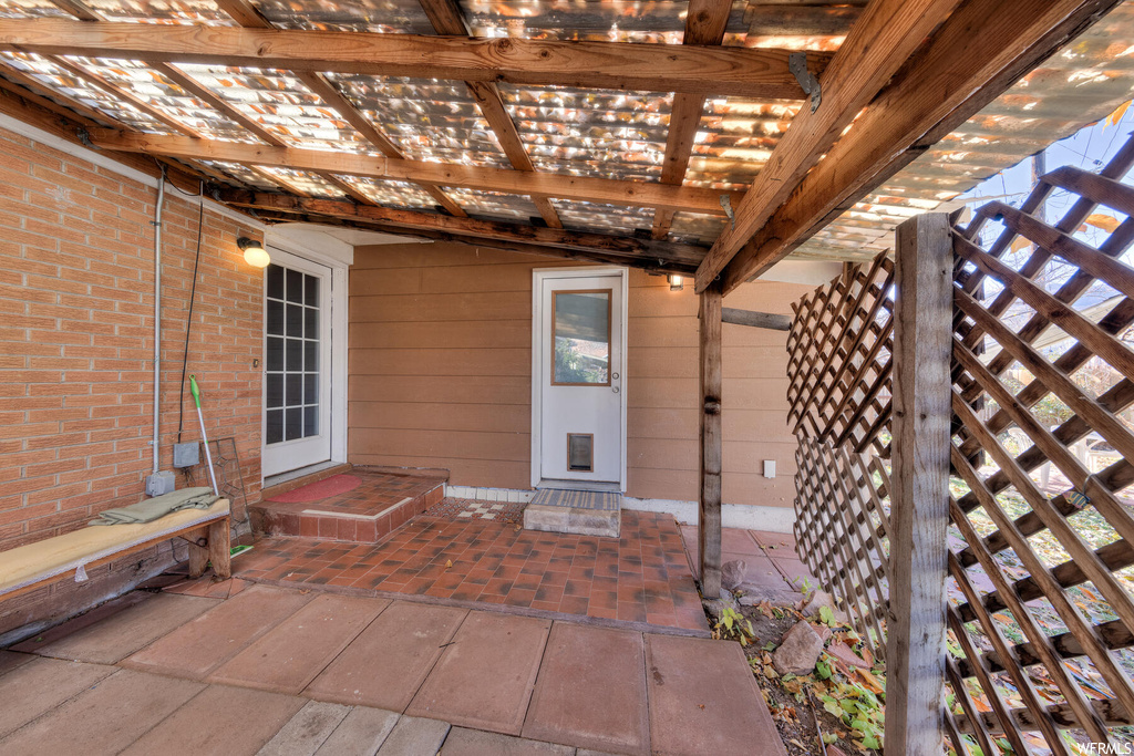 Doorway to property with a pergola
