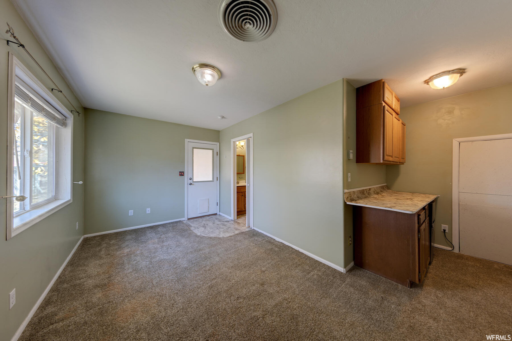Kitchen with light colored carpet
