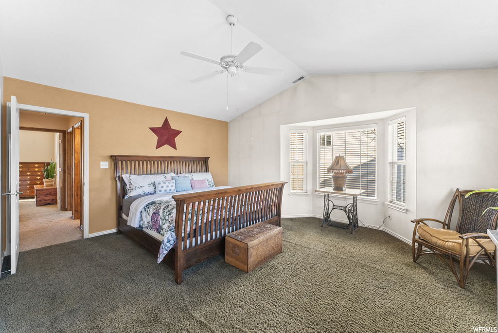 Bedroom featuring dark carpet, ceiling fan, and vaulted ceiling