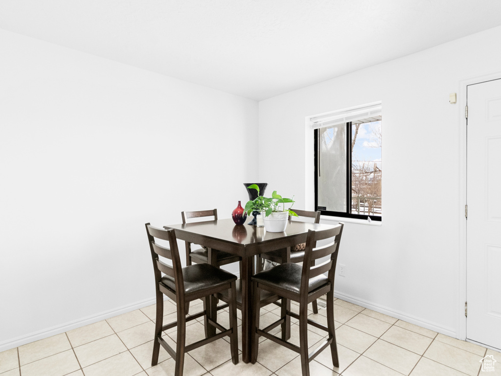 Dining area with light tile floors