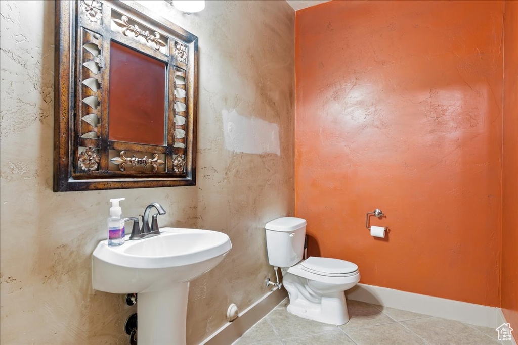 Bathroom featuring toilet and tile flooring