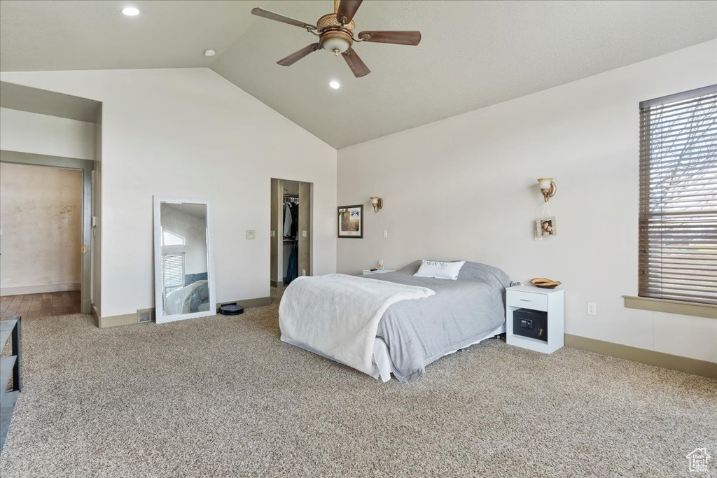Bedroom with high vaulted ceiling, carpet, and ceiling fan