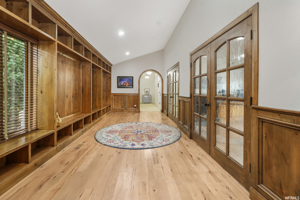 Mudroom featuring vaulted ceiling, light hardwood / wood-style flooring, and french doors