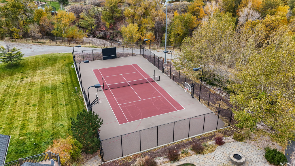 View of tennis court featuring a lawn