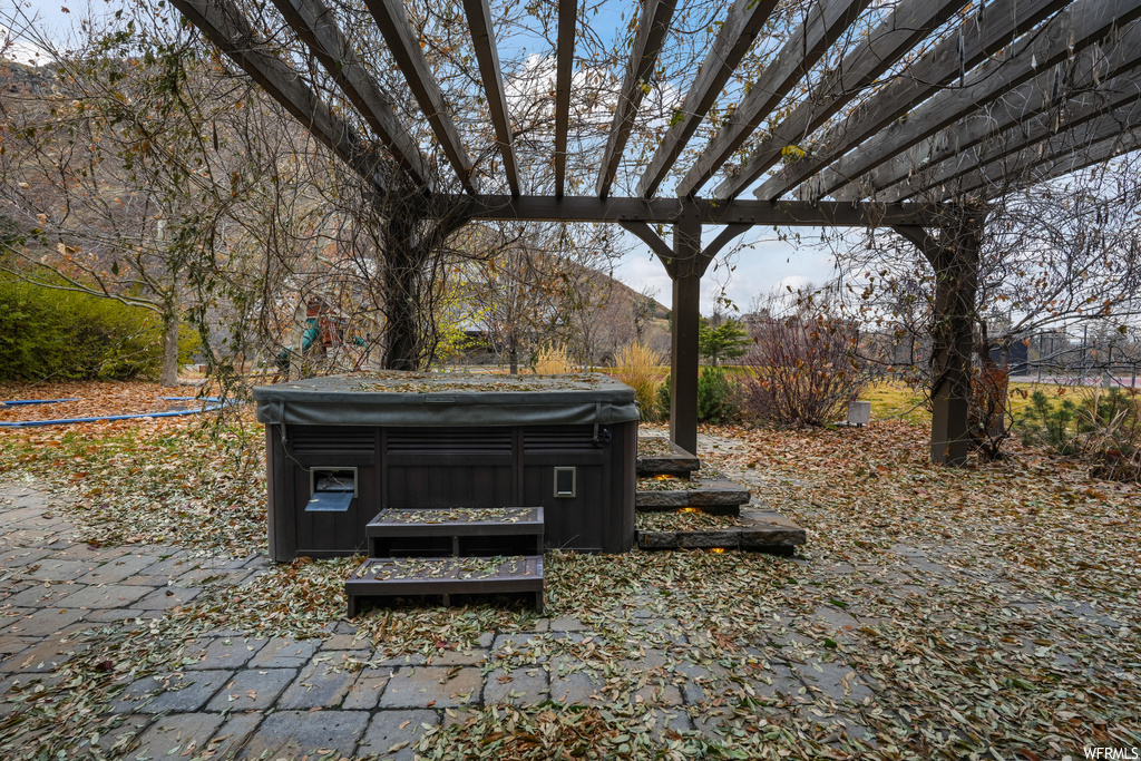 Exterior space with a hot tub