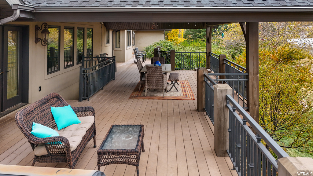 Wooden terrace featuring an outdoor living space