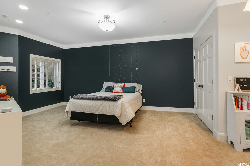 Carpeted bedroom featuring ornamental molding