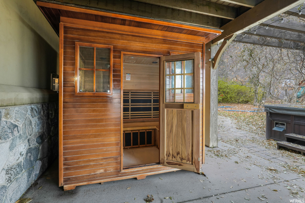 View of exterior entry featuring a hot tub