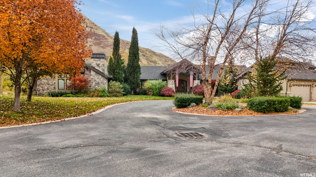 View of front of property with a garage and a mountain view