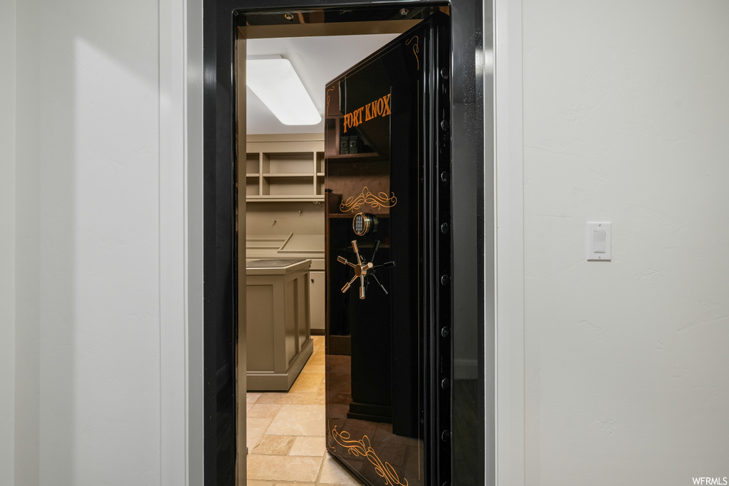 Hallway featuring light tile flooring