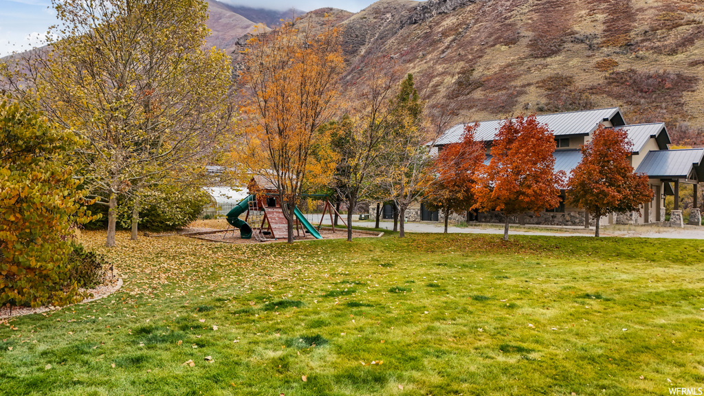 View of yard featuring a playground and a mountain view
