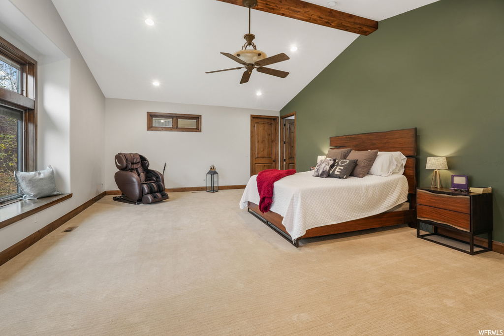 Carpeted bedroom featuring beam ceiling, ceiling fan, and high vaulted ceiling