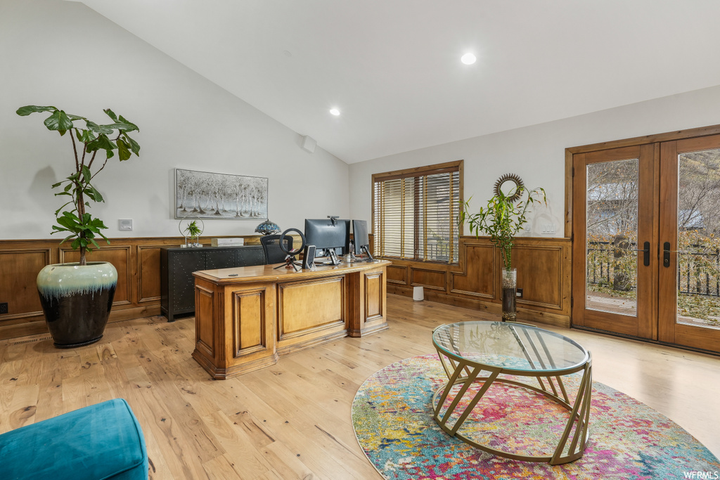 Office with light wood-type flooring, plenty of natural light, and french doors