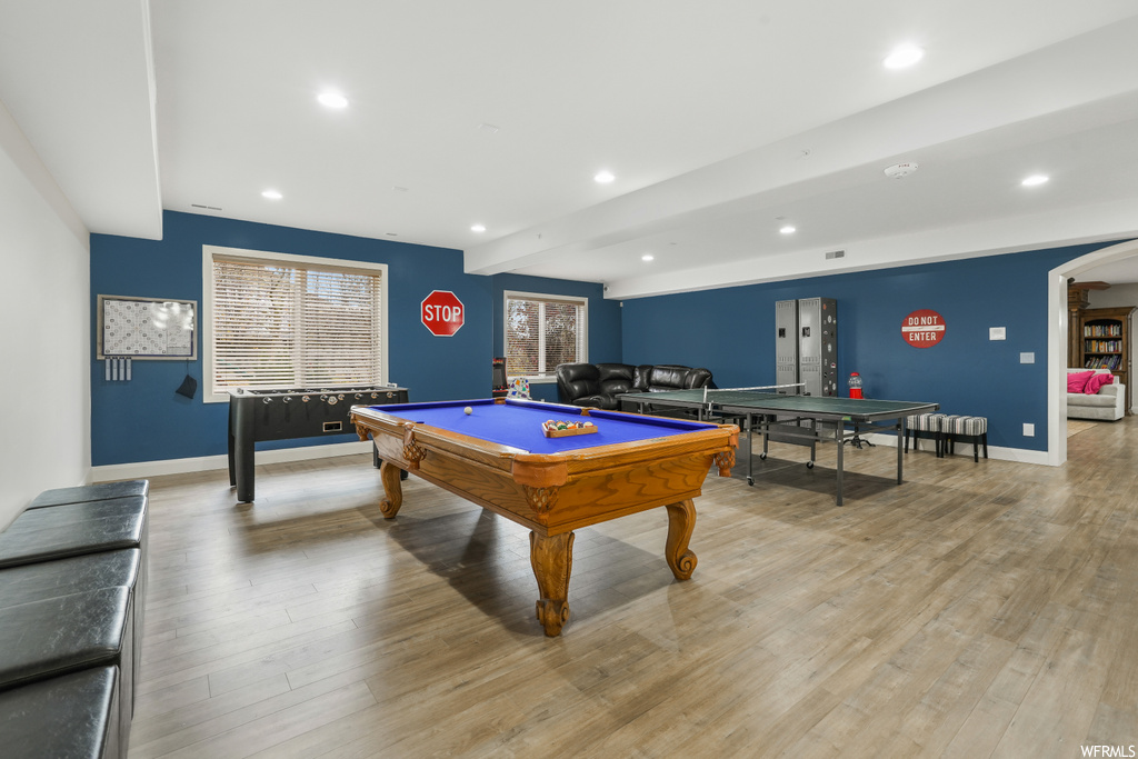 Game room featuring light hardwood / wood-style flooring, pool table, and beamed ceiling