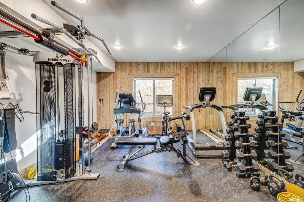 Workout area with wood walls and a healthy amount of sunlight