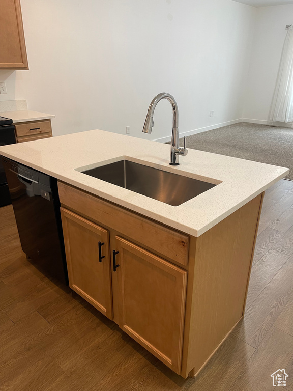Kitchen featuring range, dark hardwood / wood-style floors, light stone countertops, dishwasher, and sink