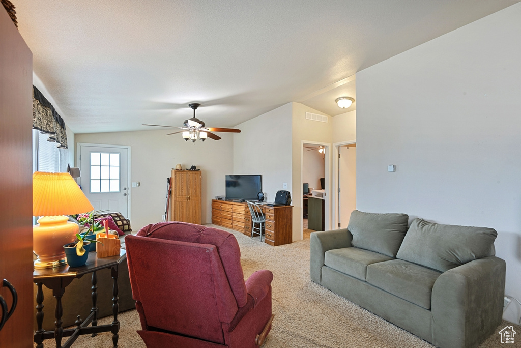 Living room featuring carpet, ceiling fan, and lofted ceiling