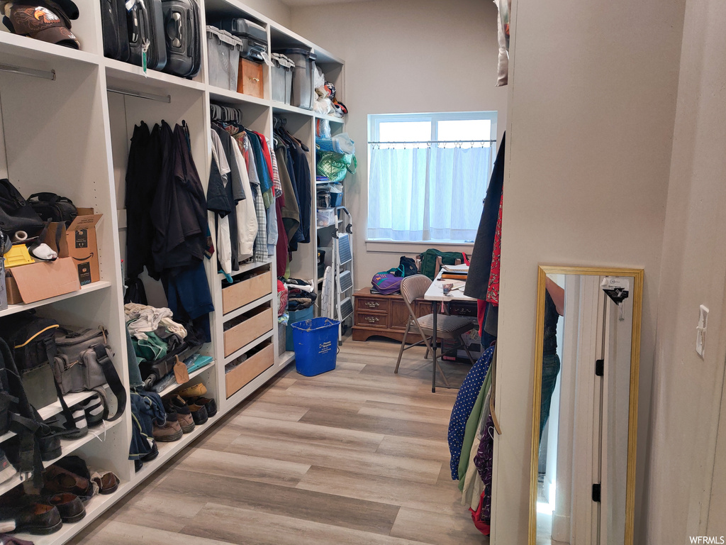 Spacious closet featuring light hardwood / wood-style floors